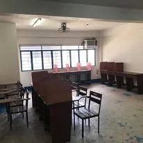 An empty school room with wooden study carrels, before the computers